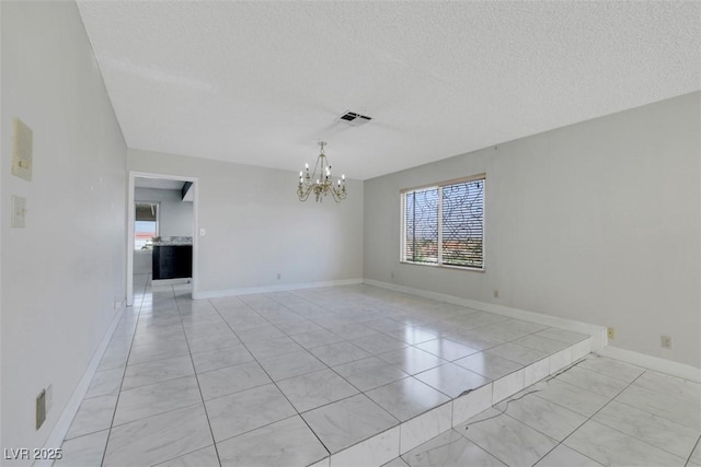 1385 Morning Sun Way, Las Vegas, NV 89110 - unfurnished room featuring plenty of natural light, a chandelier, and a textured ceiling