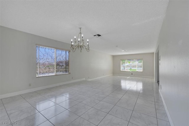 1385 Morning Sun Way, Las Vegas, NV 89110 - spare room with a chandelier, a textured ceiling, and light tile patterned flooring