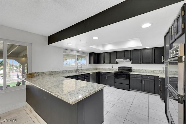 1385 Morning Sun Way, Las Vegas, NV 89110 - kitchen with stainless steel appliances, a peninsula, under cabinet range hood, light stone counters, and recessed lighting