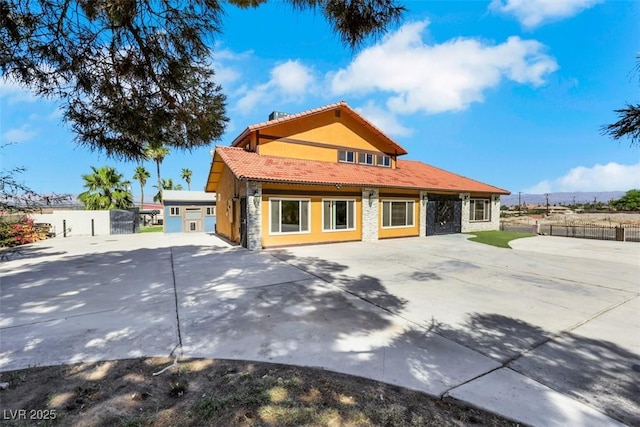 1385 Morning Sun Way, Las Vegas, NV 89110 - rear view of house with a tiled roof, stucco siding, a patio, and stone siding