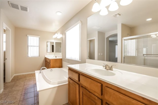 6591 Gertrude Ct, Las Vegas, NV 89141 - bathroom featuring a garden tub, two vanities, a shower stall, tile patterned floors, and a chandelier