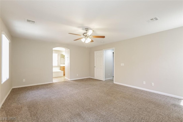 6591 Gertrude Ct, Las Vegas, NV 89141 - unfurnished room featuring ceiling fan, arched walkways, and light colored carpet
