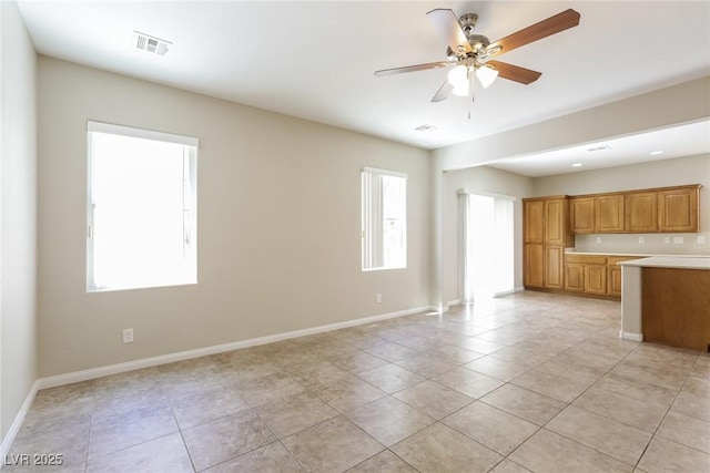 6591 Gertrude Ct, Las Vegas, NV 89141 - unfurnished living room with healthy amount of natural light, light tile patterned floors, and a ceiling fan