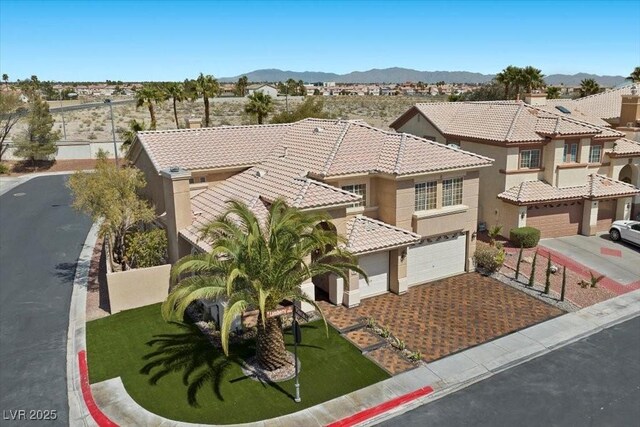 8970 Lansberry Ct, Las Vegas, NV 89147 - view of front of property featuring a garage, stucco siding, driveway, a tiled roof, and a mountain view