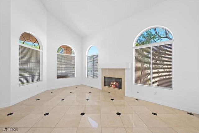 8970 Lansberry Ct, Las Vegas, NV 89147 - unfurnished living room with high vaulted ceiling, tile patterned flooring, and a fireplace