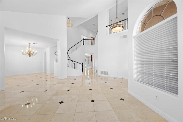 8970 Lansberry Ct, Las Vegas, NV 89147 - tiled entryway with a chandelier, stairway, and a high ceiling