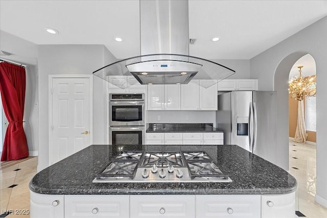8970 Lansberry Ct, Las Vegas, NV 89147 - kitchen featuring appliances with stainless steel finishes, light tile patterned flooring, arched walkways, white cabinets, and island exhaust hood