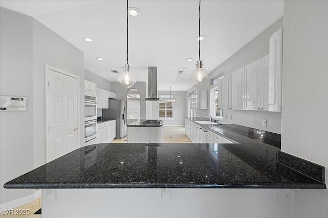 8970 Lansberry Ct, Las Vegas, NV 89147 - kitchen featuring stainless steel appliances, island range hood, white cabinets, a kitchen island, and recessed lighting