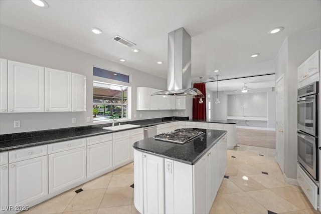 8970 Lansberry Ct, Las Vegas, NV 89147 - kitchen featuring island exhaust hood, stainless steel appliances, white cabinetry, light tile patterned flooring, and recessed lighting