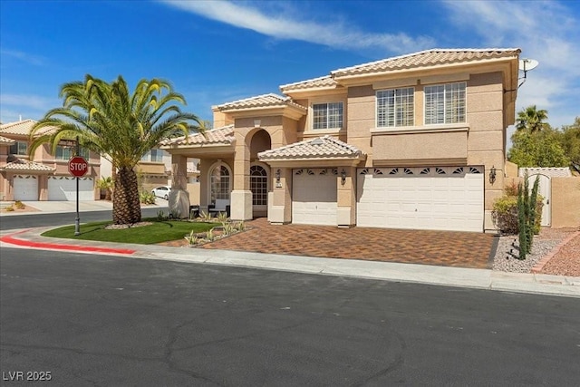 8970 Lansberry Ct, Las Vegas, NV 89147 - view of front of home with a tile roof, stucco siding, driveway, and a garage