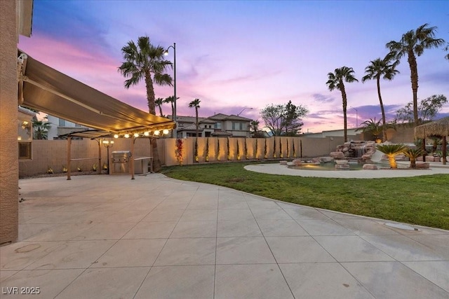 8970 Lansberry Ct, Las Vegas, NV 89147 - patio terrace at dusk featuring a patio area and a fenced backyard
