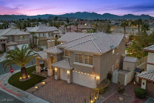 8970 Lansberry Ct, Las Vegas, NV 89147 - mediterranean / spanish-style house with an attached garage, a tiled roof, stucco siding, a mountain view, and a residential view