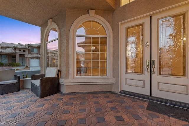 8970 Lansberry Ct, Las Vegas, NV 89147 - exterior entry at dusk with french doors and stucco siding