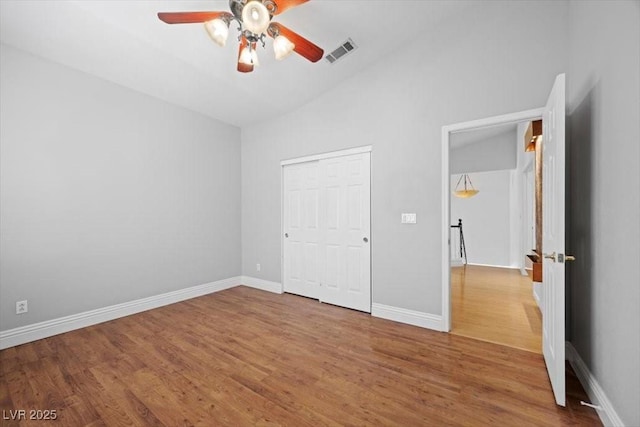 8970 Lansberry Ct, Las Vegas, NV 89147 - unfurnished bedroom featuring lofted ceiling, wood finished floors, a closet, and a ceiling fan