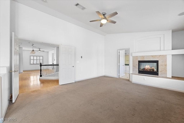 8970 Lansberry Ct, Las Vegas, NV 89147 - unfurnished living room with ceiling fan, carpet floors, a multi sided fireplace, and lofted ceiling
