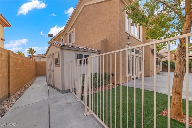 8970 Lansberry Ct, Las Vegas, NV 89147 - view of property exterior featuring a patio, a fenced backyard, and stucco siding