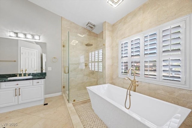8970 Lansberry Ct, Las Vegas, NV 89147 - bathroom with vanity, a soaking tub, and a stall shower