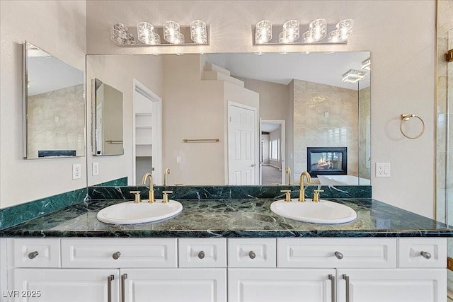 8970 Lansberry Ct, Las Vegas, NV 89147 - bathroom featuring double vanity and a fireplace