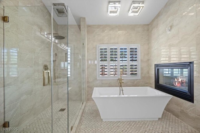 8970 Lansberry Ct, Las Vegas, NV 89147 - bathroom featuring a soaking tub, tile walls, and a stall shower