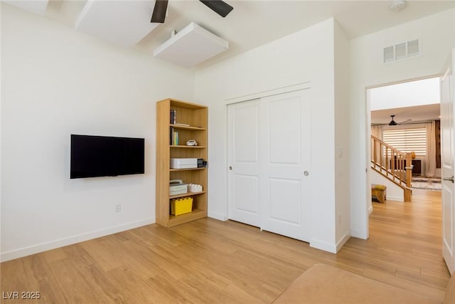 6927 Desert Finch St, North Las Vegas, NV 89084 - unfurnished bedroom with light wood-style flooring, a closet, and ceiling fan