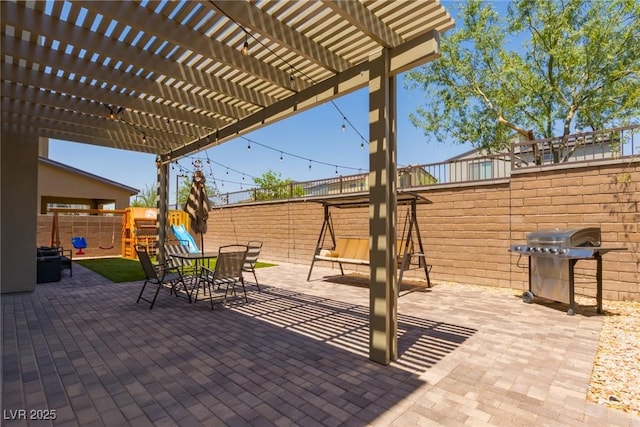 6927 Desert Finch St, North Las Vegas, NV 89084 - fenced backyard with area for grilling, a pergola, a patio area, and a playground