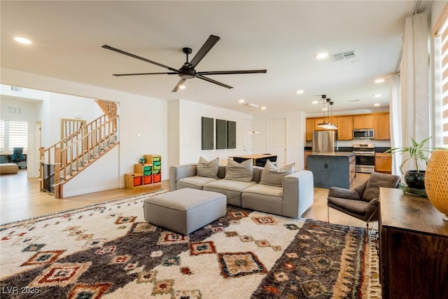 6927 Desert Finch St, North Las Vegas, NV 89084 - living room featuring stairway, ceiling fan, recessed lighting, and light wood finished floors