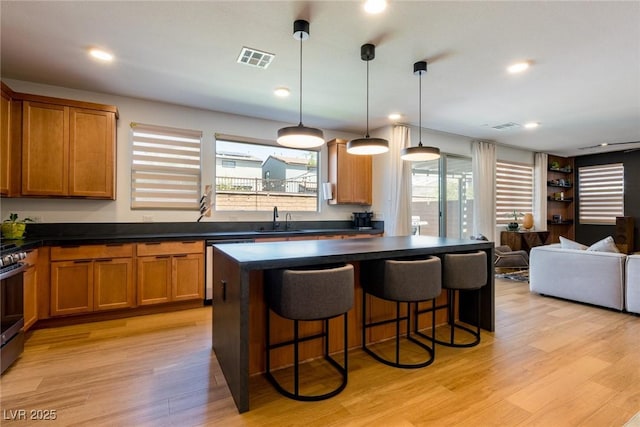 6927 Desert Finch St, North Las Vegas, NV 89084 - kitchen with dark countertops, plenty of natural light, open floor plan, and recessed lighting
