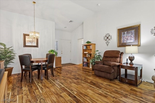 10413 Marymont Pl, Las Vegas, NV 89134 - dining area with high vaulted ceiling, dark wood-style flooring, and a chandelier