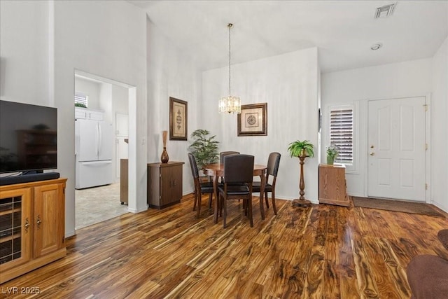 10413 Marymont Pl, Las Vegas, NV 89134 - dining space featuring wood finished floors, a chandelier, and a high ceiling