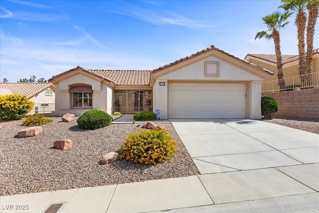 10413 Marymont Pl, Las Vegas, NV 89134 - view of front of home featuring stucco siding, a tiled roof, a garage, and driveway