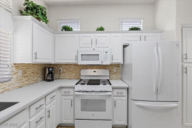 10413 Marymont Pl, Las Vegas, NV 89134 - kitchen featuring white appliances, tasteful backsplash, white cabinets, and light countertops