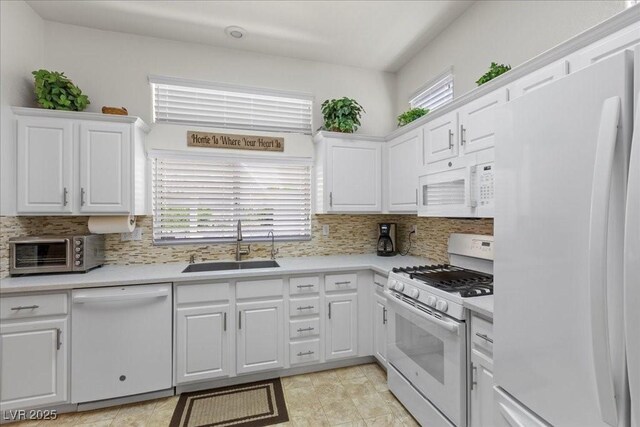 10413 Marymont Pl, Las Vegas, NV 89134 - kitchen featuring white appliances, light countertops, white cabinets, and decorative backsplash