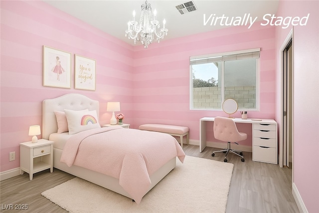 8604 Amber Autumn St, Las Vegas, NV 89131 - bedroom with light wood-type flooring and a chandelier
