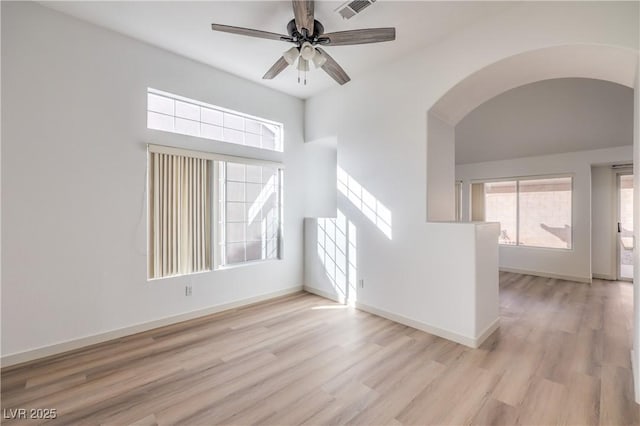 7021 Feather Pine St, Las Vegas, NV 89131 - empty room featuring arched walkways, healthy amount of natural light, light wood-style flooring, and ceiling fan