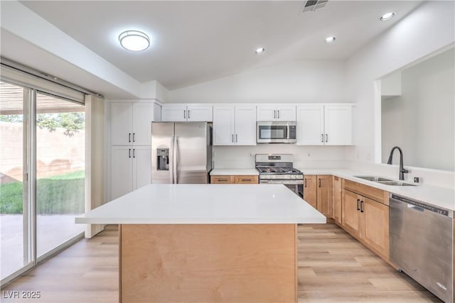 7021 Feather Pine St, Las Vegas, NV 89131 - kitchen featuring appliances with stainless steel finishes, light wood finished floors, lofted ceiling, light countertops, and recessed lighting