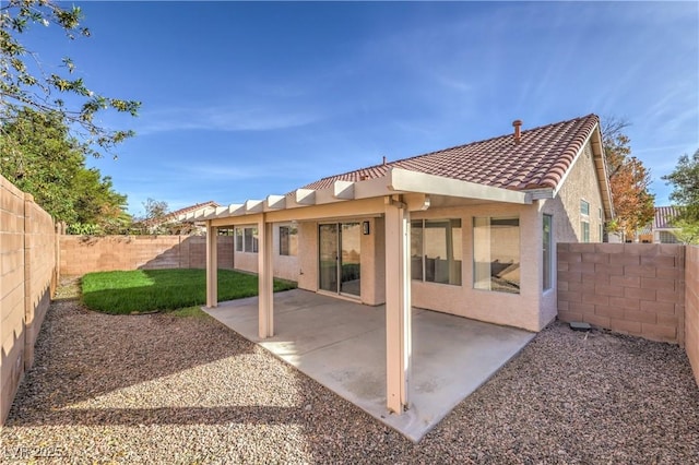 7021 Feather Pine St, Las Vegas, NV 89131 - back of house featuring a fenced backyard, stucco siding, a tiled roof, and a patio