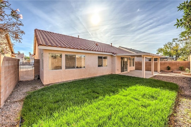 7021 Feather Pine St, Las Vegas, NV 89131 - rear view of property featuring stucco siding, a tiled roof, a fenced backyard, and a patio area