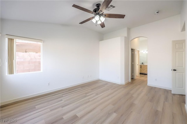 7021 Feather Pine St, Las Vegas, NV 89131 - spare room featuring arched walkways, ceiling fan, light wood finished floors, a smoke detector, and vaulted ceiling