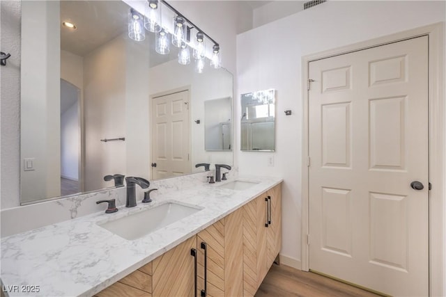 7021 Feather Pine St, Las Vegas, NV 89131 - full bathroom featuring double vanity and wood finished floors