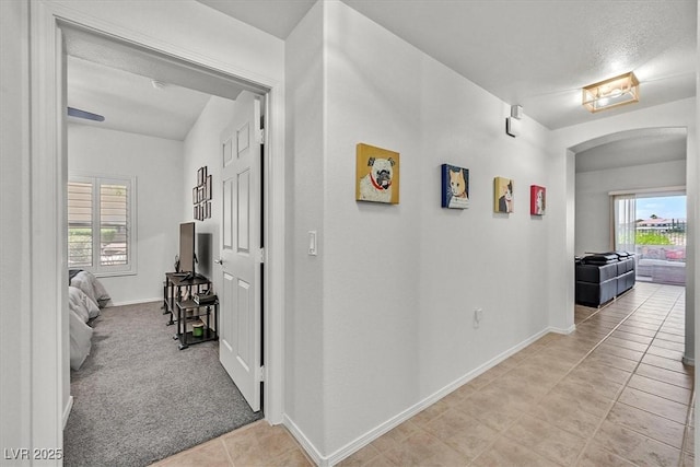 10640 Amber Ridge Dr Unit 101, Las Vegas, NV 89144 - corridor with arched walkways, light tile patterned floors, and healthy amount of natural light