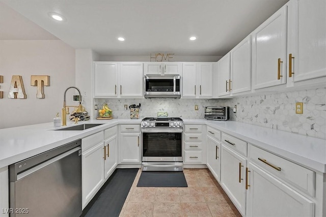 10640 Amber Ridge Dr Unit 101, Las Vegas, NV 89144 - kitchen featuring stainless steel appliances, white cabinetry, backsplash, light countertops, and recessed lighting