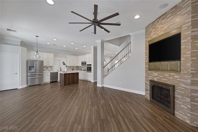 12 Golden View St, Henderson, NV 89012 - unfurnished living room with a ceiling fan, dark wood-style flooring, crown molding, a fireplace, and recessed lighting