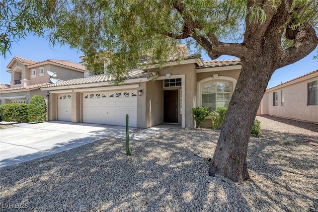 12 Golden View St, Henderson, NV 89012 - mediterranean / spanish home featuring a garage, stucco siding, driveway, and a tiled roof