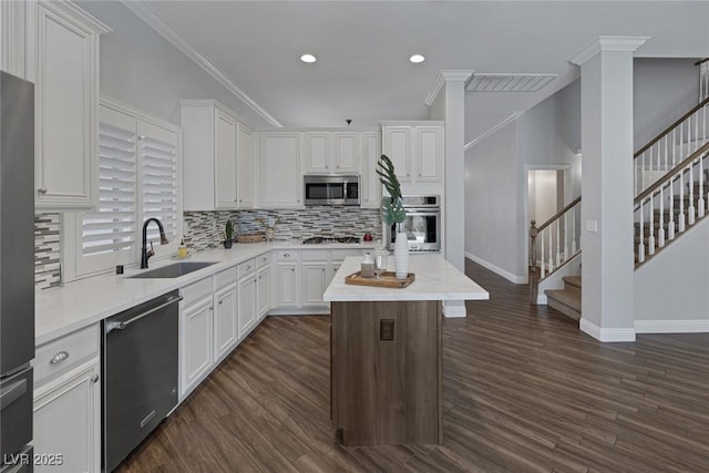 12 Golden View St, Henderson, NV 89012 - kitchen featuring appliances with stainless steel finishes, white cabinets, light countertops, ornamental molding, and recessed lighting