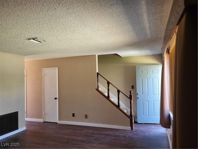 745 Greenbriar Townhouse Way, Las Vegas, NV 89121 - unfurnished living room featuring a textured ceiling, wood finished floors, and stairway