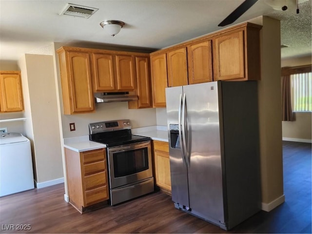 745 Greenbriar Townhouse Way, Las Vegas, NV 89121 - kitchen with appliances with stainless steel finishes, washer / dryer, under cabinet range hood, light countertops, and dark wood finished floors