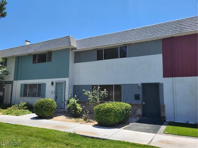 745 Greenbriar Townhouse Way, Las Vegas, NV 89121 - townhome / multi-family property featuring mansard roof, a shingled roof, and stucco siding