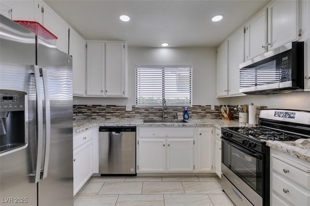 368 Umbria Way, Henderson, NV 89014 - kitchen featuring appliances with stainless steel finishes, white cabinets, backsplash, and recessed lighting