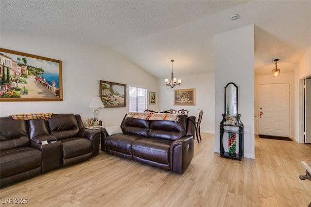 368 Umbria Way, Henderson, NV 89014 - living room with a chandelier, light wood-style floors, lofted ceiling, and a textured ceiling