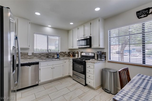 368 Umbria Way, Henderson, NV 89014 - kitchen with stainless steel appliances, white cabinets, recessed lighting, and light stone counters